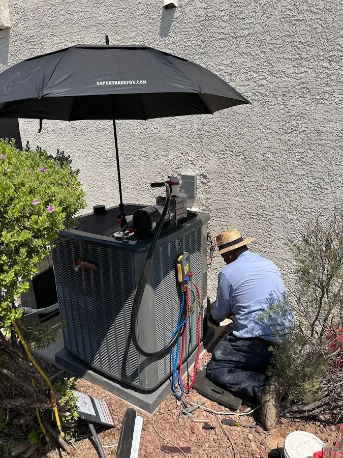 HVAC technician performing outdoor AC maintenance in Glassmanor