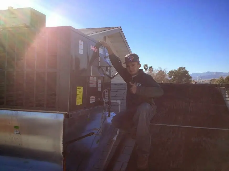 HVAC technician performing HVAC Inspection on a rooftop unit in Glassmanor